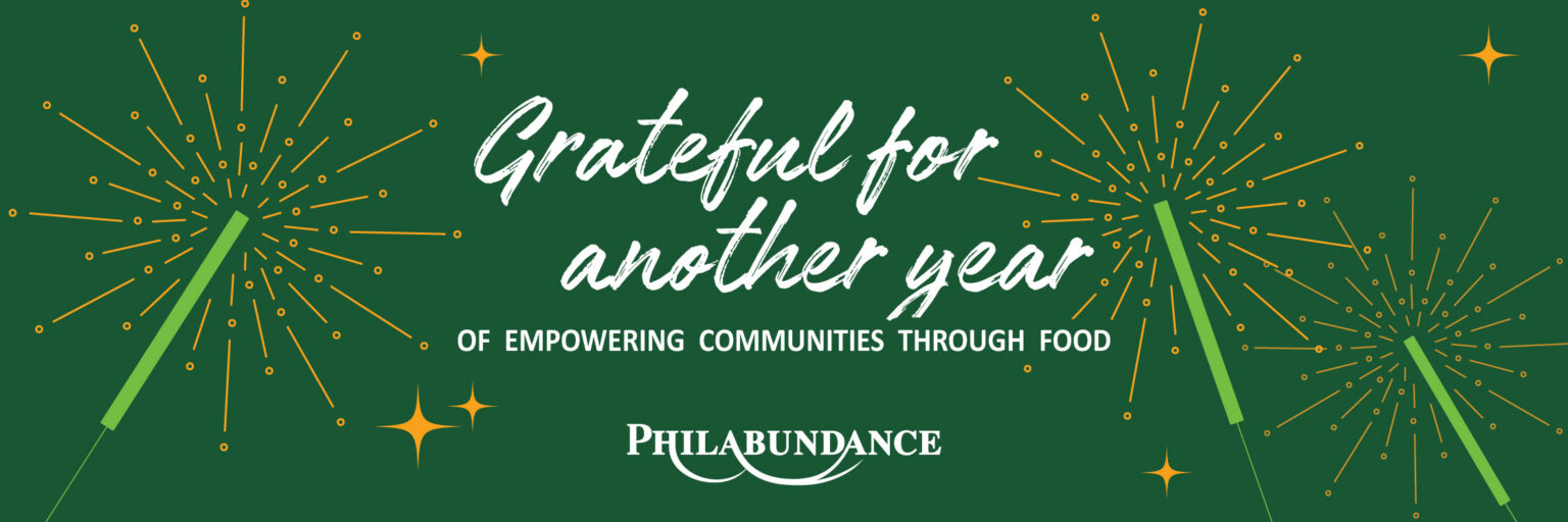 A look back at a year of empowering communities through food | Philabundance | graphic banner with dark green background, white text, & abstract sparklers