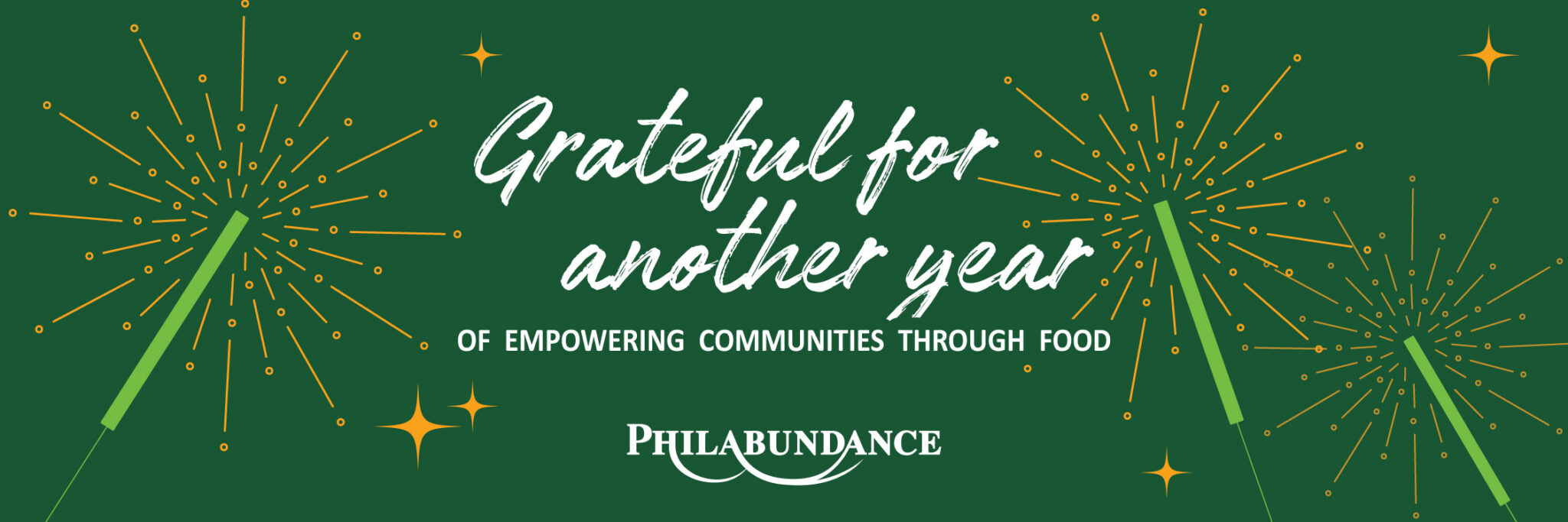 A look back at a year of empowering communities through food | Philabundance | graphic banner with dark green background, white text, & abstract sparklers