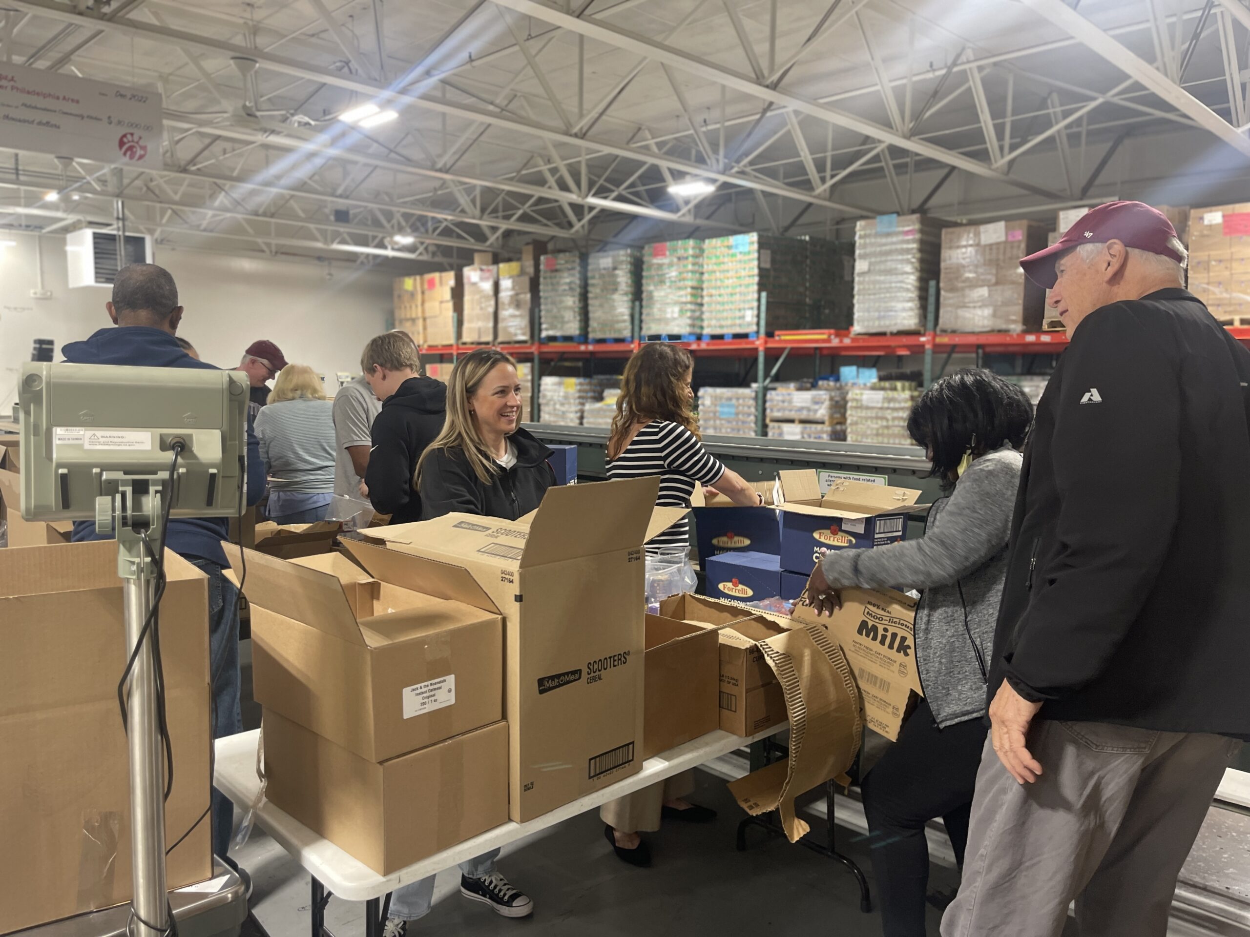 A group of galloway volunteers organizing and opening cardboard boxes